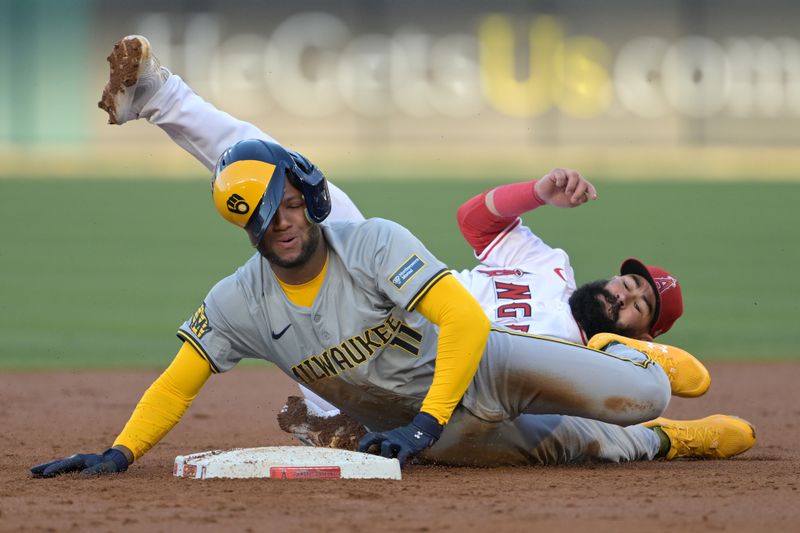 Jun 19, 2024; Anaheim, California, USA;  Los Angeles Angels second baseman Luis Guillorme (15) tags Milwaukee Brewers right fielder Jackson Chourio (11) out at second on an attempted stolen base in the second inning at Angel Stadium. Mandatory Credit: Jayne Kamin-Oncea-USA TODAY Sports