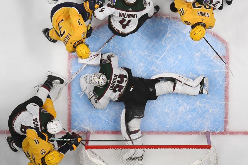 Nov 11, 2023; Nashville, Tennessee, USA; Arizona Coyotes goaltender Connor Ingram (39) makes a save during the second period against Nashville Predators left wing Filip Forsberg (9) at Bridgestone Arena. Mandatory Credit: Christopher Hanewinckel-USA TODAY Sports