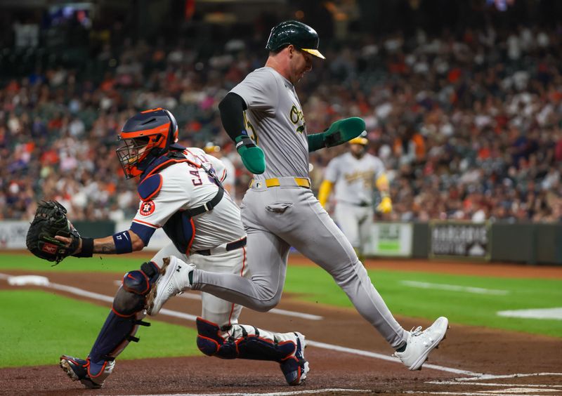 Sep 10, 2024; Houston, Texas, USA; Oakland Athletics designated hitter Brent Rooker (25) scores at home plate infront of Houston Astros catcher Victor Caratini (17) in the first inning at Minute Maid Park. Mandatory Credit: Thomas Shea-Imagn Images