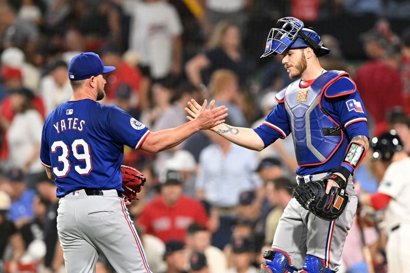 Aug 14, 2024; Boston, Massachusetts, USA; Texas Rangers pitcher Kirby Yates (39) high-fives catcher Jonah Heim (28) after a game against the Boston Red Sox at Fenway Park. Mandatory Credit: Brian Fluharty-USA TODAY Sports