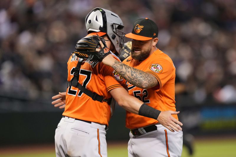 Sep 2, 2023; Phoenix, Arizona, USA; Baltimore Orioles relief pitcher Joey Krehbiel (52) hugs Baltimore Orioles catcher James McCann (27) after defeating the Arizona Diamondbacks at Chase Field. Mandatory Credit: Joe Camporeale-USA TODAY Sports