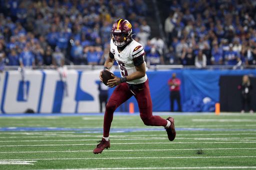 Washington Commanders quarterback Jayden Daniels (5) runs the ball against the Detroit Lions during the second half of an NFL football divisional playoff game, Saturday, Jan. 18, 2025, in Detroit. (AP Photo/Mike Mulholland)