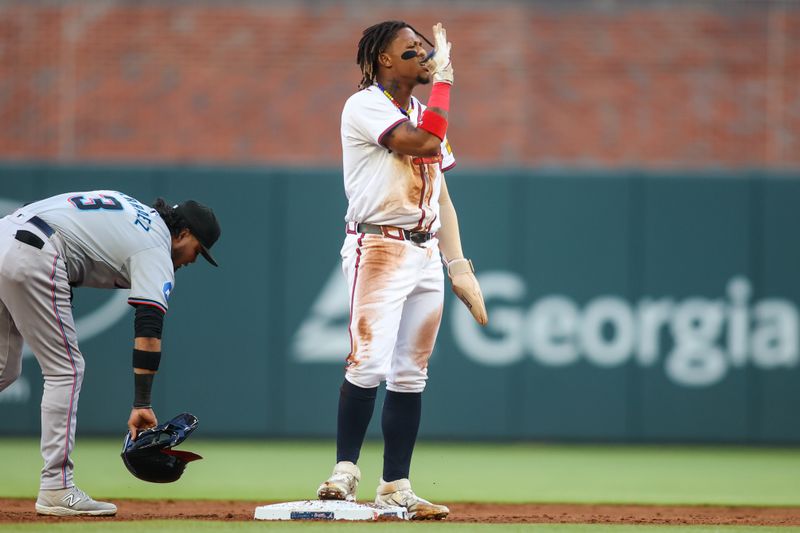 Apr 22, 2024; Atlanta, Georgia, USA; Atlanta Braves right fielder Ronald Acuna Jr. (13) reacts after setting the franchise record for career stolen bases against the Miami Marlins in the first inning at Truist Park. Mandatory Credit: Brett Davis-USA TODAY Sports