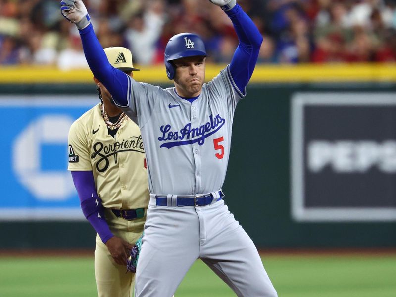 Apr 30, 2024; Phoenix, Arizona, USA; Los Angeles Dodgers first baseman Freddie Freeman celebrates after hitting a fourth inning double against the Arizona Diamondbacks at Chase Field. Mandatory Credit: Mark J. Rebilas-USA TODAY Sports