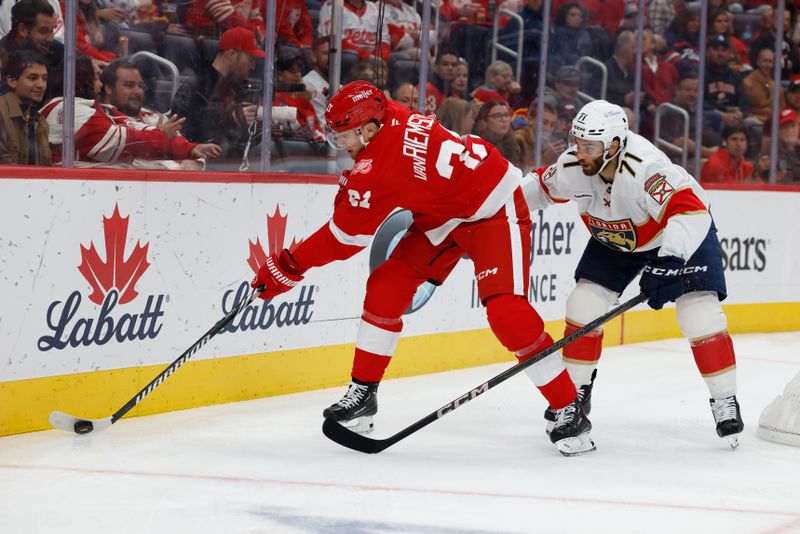Oct 15, 2025; Detroit, Michigan, USA;  Detroit Red Wings left wing James van Riemsdyk (21) skates with the puck chased by Florida Panthers center Luke Kunin (71) in the second period at Little Caesars Arena. Mandatory Credit: Rick Osentoski-Imagn Images