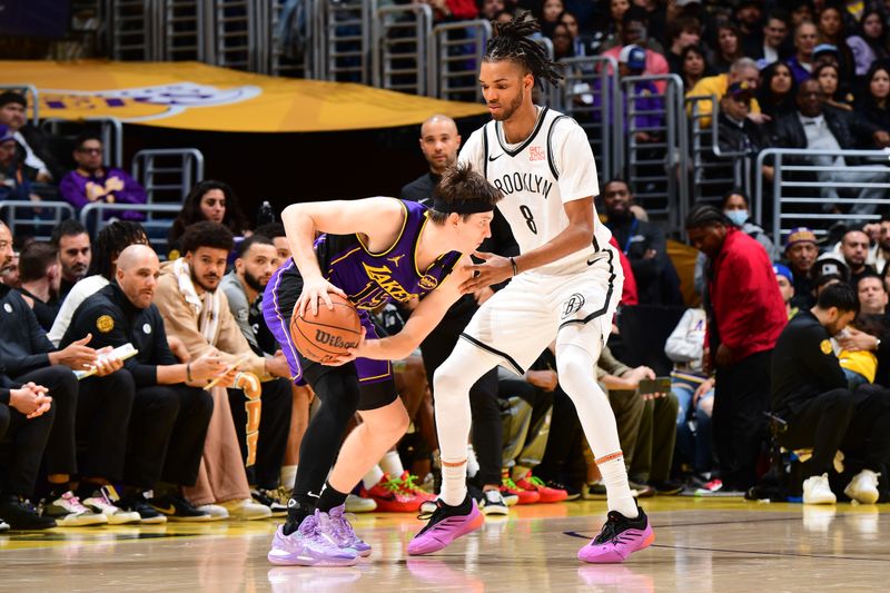 LOS ANGELES, CA - JANUARY 17:  Austin Reaves #15 of the Los Angeles Lakers looks to pass the ball during the game against the Brooklyn Nets on January 17, 2025 at Crypto.Com Arena in Los Angeles, California. NOTE TO USER: User expressly acknowledges and agrees that, by downloading and/or using this Photograph, user is consenting to the terms and conditions of the Getty Images License Agreement. Mandatory Copyright Notice: Copyright 2025 NBAE (Photo by Adam Pantozzi/NBAE via Getty Images)