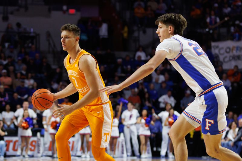 Jan 7, 2025; Gainesville, Florida, USA; Tennessee Volunteers forward Igor Milicic Jr. (7) dribbles the ball away from Florida Gators forward Alex Condon (21) during the first half at Exactech Arena at the Stephen C. O'Connell Center. Mandatory Credit: Matt Pendleton-Imagn Images