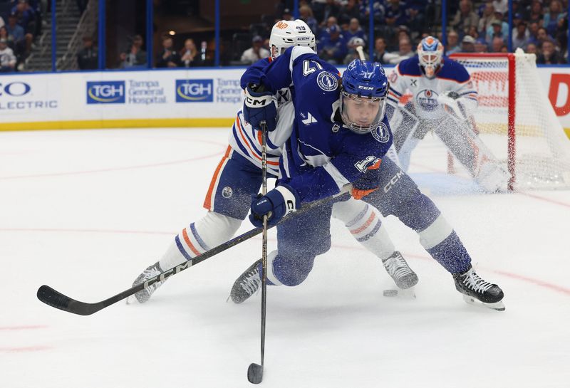 Nov 20, 2025; Tampa, Florida, USA; Edmonton Oilers defenseman Ty Emberson (49) defends against Tampa Bay Lightning center Dominic James (17) during the first period at Benchmark International Arena. Mandatory Credit: Kim Klement Neitzel-Imagn Images Nov 20, 2025; Tampa, Florida, USA; Edmonton Oilers defenseman Ty Emberson (49) defends against Tampa Bay Lightning center Dominic James (17) during the first period at Benchmark International Arena. Mandatory Credit: Kim Klement Neitzel-Imagn Images