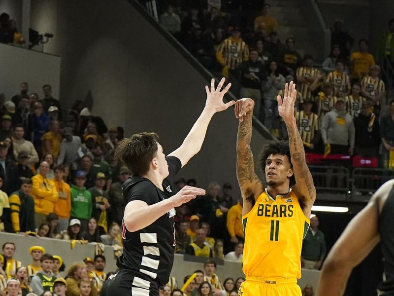 Jan 13, 2024; Waco, Texas, USA; Baylor Bears forward Jalen Bridges (11) shoots over Cincinnati Bearcats guard Simas Lukosius (41) during the second half at Paul and Alejandra Foster Pavilion. Mandatory Credit: Raymond Carlin III-USA TODAY Sports