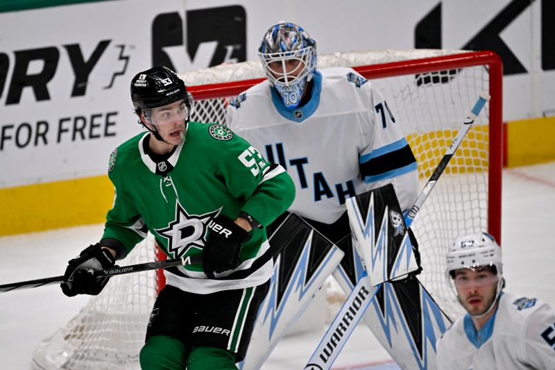 Apr 12, 2025; Dallas, Texas, USA; Dallas Stars center Wyatt Johnston (53) screens Utah Hockey Club goaltender Karel Vejmelka (70) during the first period at the American Airlines Center. Mandatory Credit: Jerome Miron-Imagn Images