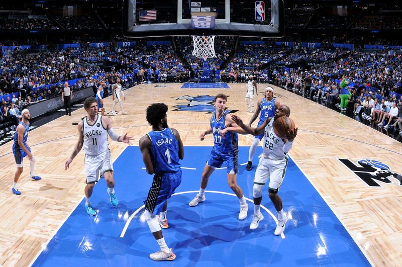 ORLANDO, FL - APRIL 14: Khris Middleton #22 of the Milwaukee Bucks handles the ball during the game against the Orlando Magic on April 14, 2024 at Kia Center in Orlando, Florida. NOTE TO USER: User expressly acknowledges and agrees that, by downloading and or using this photograph, User is consenting to the terms and conditions of the Getty Images License Agreement. Mandatory Copyright Notice: Copyright 2024 NBAE (Photo by Fernando Medina/NBAE via Getty Images)