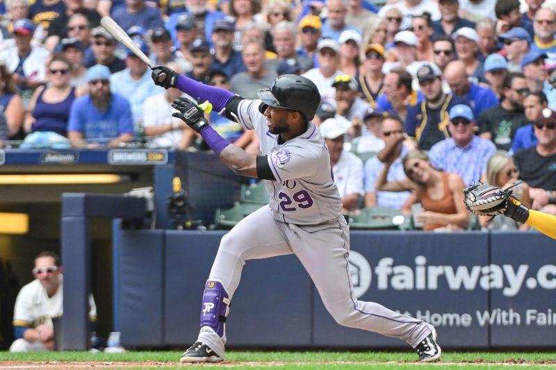 Aug 9, 2023; Milwaukee, Wisconsin, USA; Colorado Rockies designated hitter Jurickson Profar (29) watches after hitting a solo home run against the Milwaukee Brewers in the fourth inning at American Family Field. Mandatory Credit: Benny Sieu-USA TODAY Sports