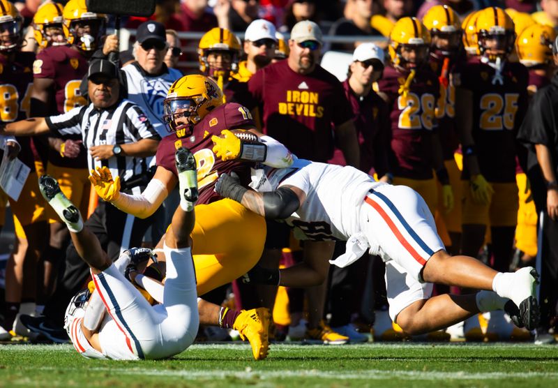 Nov 25, 2023; Tempe, Arizona, USA; Arizona State Sun Devils tight end Jalin Conyers (12) is tackled by the Arizona Wildcats in the first half of the Territorial Cup at Mountain America Stadium. Mandatory Credit: Mark J. Rebilas-USA TODAY Sports