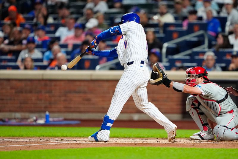 Sep 22, 2024; New York City, New York, USA;  New York Mets second baseman Jose Iglesias (11) hits a single against the Philadelphia Phillies during the first inning at Citi Field. Mandatory Credit: Gregory Fisher-Imagn Images