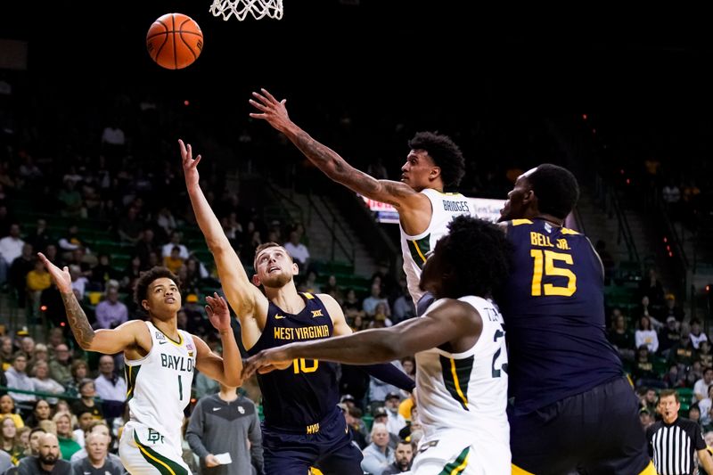 Feb 13, 2023; Waco, Texas, USA; West Virginia Mountaineers guard Erik Stevenson (10) drives past  Baylor Bears guard Keyonte George (1) to the basket during the first half at Ferrell Center. Mandatory Credit: Raymond Carlin III-USA TODAY Sports