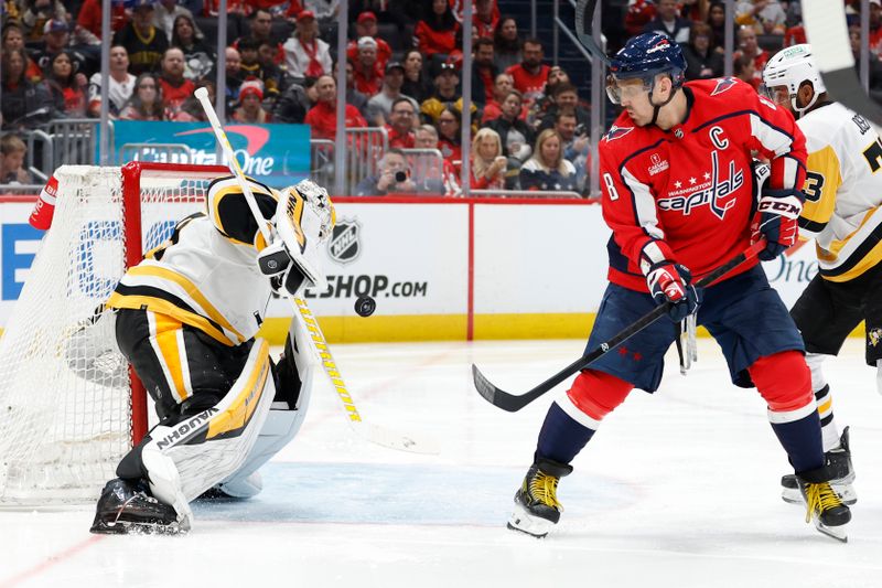 Apr 4, 2024; Washington, District of Columbia, USA; Pittsburgh Penguins goaltender Alex Nedeljkovic (39) makes a save in front of Washington Capitals left wing Alex Ovechkin (8) /in the third period at Capital One Arena. Mandatory Credit: Geoff Burke-USA TODAY Sports