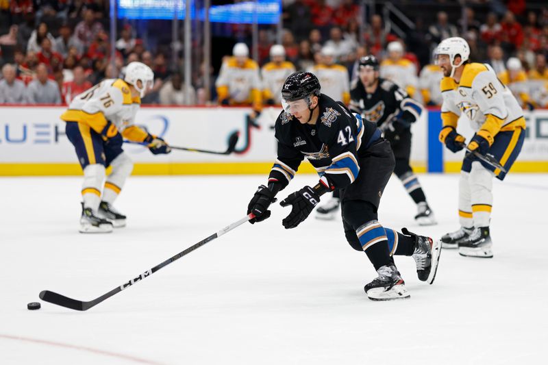 Nov 6, 2024; Washington, District of Columbia, USA; Washington Capitals defenseman Martin Fehervary (42) skates with the puck as Nashville Predators defenseman Roman Josi (59) chases in the first period at Capital One Arena. Mandatory Credit: Geoff Burke-Imagn Images