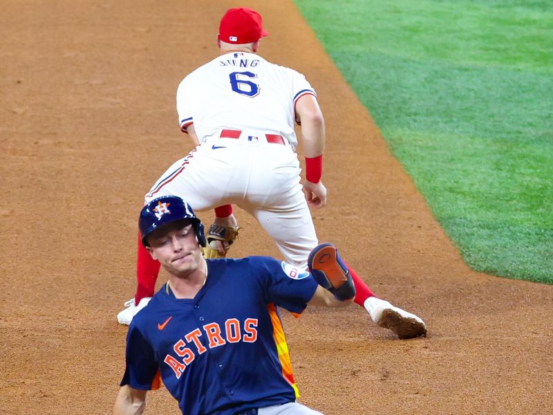 Aug 6, 2024; Arlington, Texas, USA; Houston Astros designated hitter Zach Dezenzo (9) slides into third base in front of Texas Rangers third baseman Josh Jung (6) during the fourth inning at Globe Life Field. Mandatory Credit: Kevin Jairaj-USA TODAY Sports