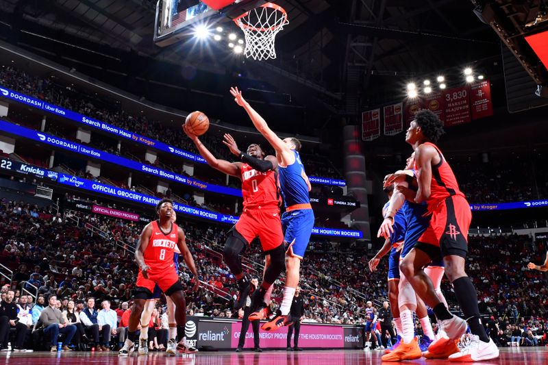 HOUSTON, TX - FEBRUARY 12: Aaron Holiday #0 of the Houston Rockets drives to the basket during the game against the New York Knicks on February 12, 2024 at the Toyota Center in Houston, Texas. NOTE TO USER: User expressly acknowledges and agrees that, by downloading and or using this photograph, User is consenting to the terms and conditions of the Getty Images License Agreement. Mandatory Copyright Notice: Copyright 2024 NBAE (Photo by Logan Riely/NBAE via Getty Images)