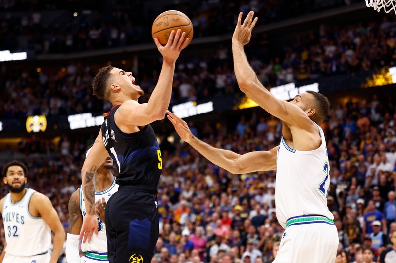 DENVER, COLORADO - MAY 19: Michael Porter Jr. #1 of the Denver Nuggets drives to the basket against Rudy Gobert #27 of the Minnesota Timberwolves during the first quarter in Game Seven of the Western Conference Second Round Playoffs at Ball Arena on May 19, 2024 in Denver, Colorado. NOTE TO USER: User expressly acknowledges and agrees that, by downloading and or using this photograph, User is consenting to the terms and conditions of the Getty Images License Agreement. (Photo by C. Morgan Engel/Getty Images)