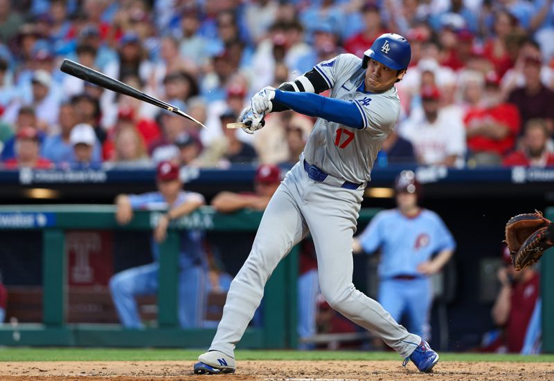 Jul 11, 2024; Philadelphia, Pennsylvania, USA; Los Angeles Dodgers two-way player Shohei Ohtani (17) breaks his bat while hitting into a ground out during the seventh inning against the Philadelphia Phillies at Citizens Bank Park. Mandatory Credit: Bill Streicher-USA TODAY Sports