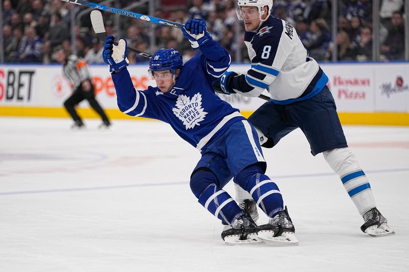 Jan 19, 2023; Toronto, Ontario, CAN; Toronto Maple Leafs forward Mitchell Marner (16) skates past Winnipeg Jets forward Saku Maenalanen (8) during the third period at Scotiabank Arena. Mandatory Credit: John E. Sokolowski-USA TODAY Sports