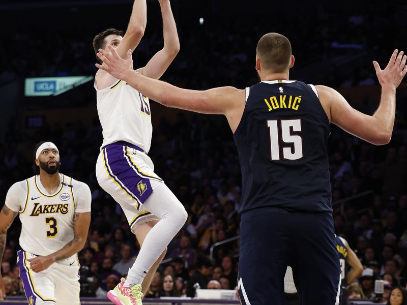 LOS ANGELES, CALIFORNIA - NOVEMBER 23:  Austin Reaves #15 of the Los Angeles Lakers takes a shot against Nikola Jokic #15 of the Denver Nuggets in the second half at Crypto.com Arena on November 23, 2024 in Los Angeles, California.  NOTE TO USER: User expressly acknowledges and agrees that, by downloading and/or using this photograph, user is consenting to the terms and conditions of the Getty Images License Agreement. (Photo by Ronald Martinez/Getty Images)