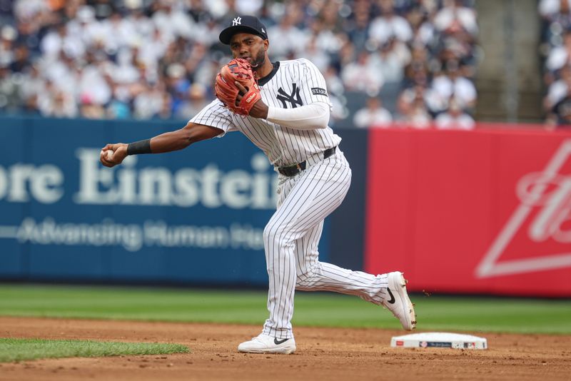 May 4, 2025; Bronx, New York, USA; New York Yankees third baseman Pablo Reyes (19) throws the ball to first base for an out during the second inning against the Tampa Bay Rays at Yankee Stadium. Mandatory Credit: Vincent Carchietta-Imagn Images