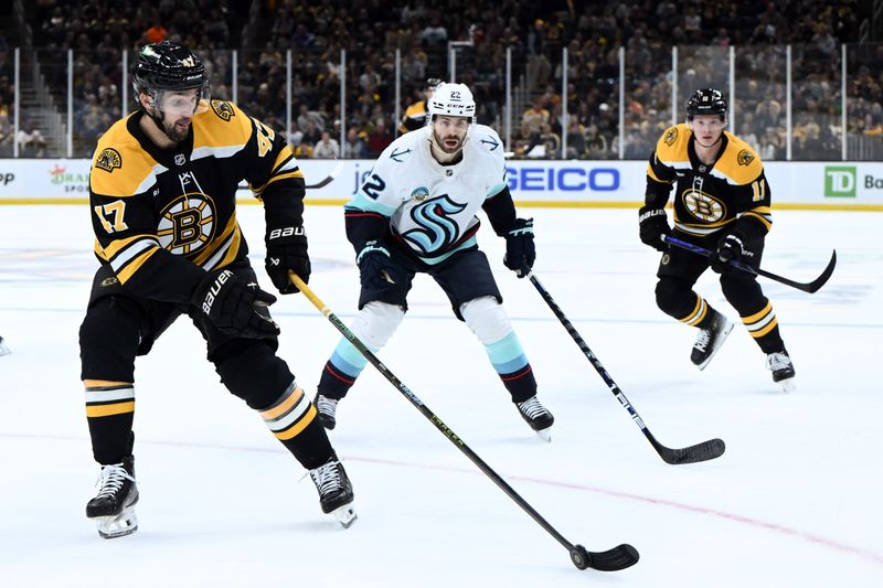 Nov 3, 2024; Boston, Massachusetts, USA; Boston Bruins center Mark Kastelic (47) controls the puck against Seattle Kraken right wing Oliver Bjorkstrand (22) during the first period at the TD Garden. Mandatory Credit: Brian Fluharty-Imagn Images