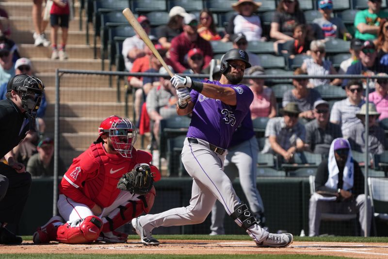 Mar 10, 2025; Tempe, Arizona, USA; Colorado Rockies Nick Martini hits against the Los Angeles Angels in the first inning at Tempe Diablo Stadium. Mandatory Credit: Rick Scuteri-Imagn Images