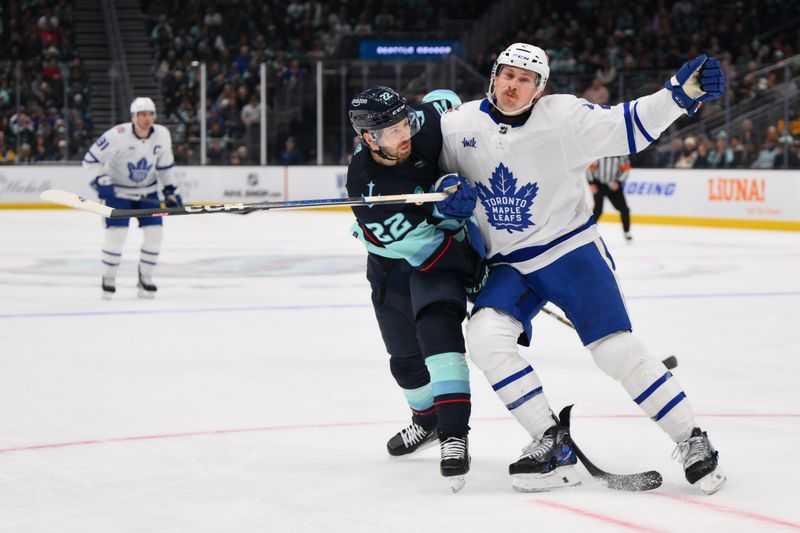 Jan 21, 2024; Seattle, Washington, USA; Seattle Kraken right wing Oliver Bjorkstrand (22) and Toronto Maple Leafs defenseman Simon Benoit (2) collide during the second period at Climate Pledge Arena. Mandatory Credit: Steven Bisig-USA TODAY Sports