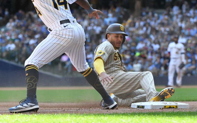 Aug 27, 2023; Milwaukee, Wisconsin, USA; San Diego Padres third baseman Manny Machado (13) slides in safely into third base safely agains the Milwaukee Brewers in the sixth inning at American Family Field. Mandatory Credit: Michael McLoone-USA TODAY Sports