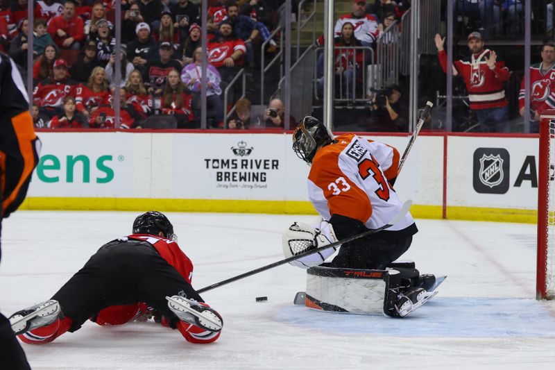 Jan 18, 2025; Newark, New Jersey, USA; Philadelphia Flyers goaltender Samuel Ersson (33) makes a save on New Jersey Devils right wing Nathan Bastian (14) during the second period at Prudential Center. Mandatory Credit: Ed Mulholland-Imagn Images