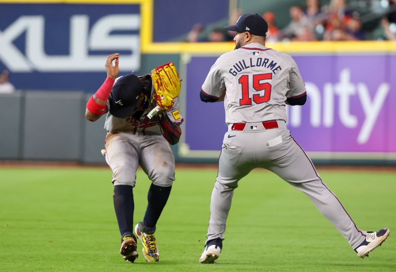 Apr 17, 2024; Houston, Texas, USA; Atlanta Braves right fielder Ronald Acuna Jr. (13) ducks to get out of the way of second base Luis Guillorme (15) throw against the Houston Astros in the first inning at Minute Maid Park. Mandatory Credit: Thomas Shea-USA TODAY Sports