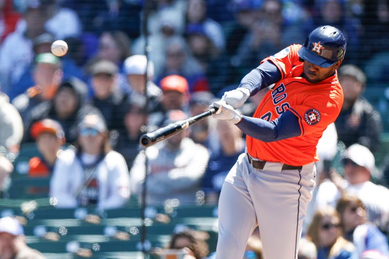 Apr 25, 2024; Chicago, Illinois, USA; Houston Astros outfielder Yordan Alvarez (44) hits an RBI-sacrifice fly against the Chicago Cubs during the first inning at Wrigley Field. Mandatory Credit: Kamil Krzaczynski-USA TODAY Sports