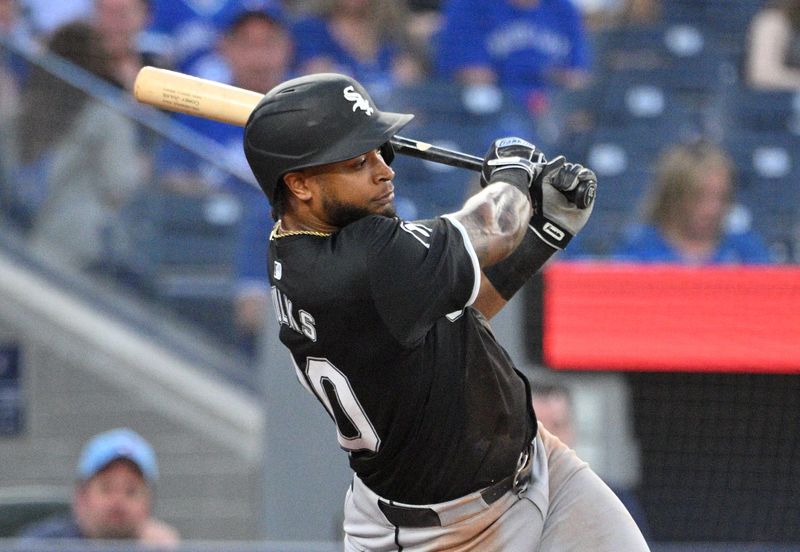 May 21, 2024; Toronto, Ontario, CAN;   Chicago White Sox right fielder Corey Julks (30) hits a two RBI single against the Toronto Blue Jays in the fifth inning at Rogers Centre. Mandatory Credit: Dan Hamilton-USA TODAY Sports