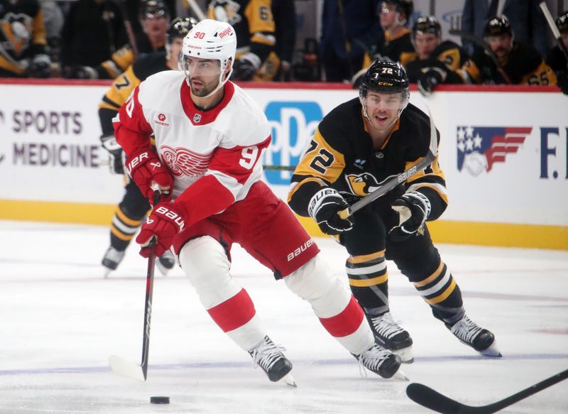 Nov 13, 2024; Pittsburgh, Pennsylvania, USA;  Detroit Red Wings center Joe Veleno (90) skates with the puck as Pittsburgh Penguins left wing Anthony Beauvillier (72) chases during the second period at PPG Paints Arena. Mandatory Credit: Charles LeClaire-Imagn Images