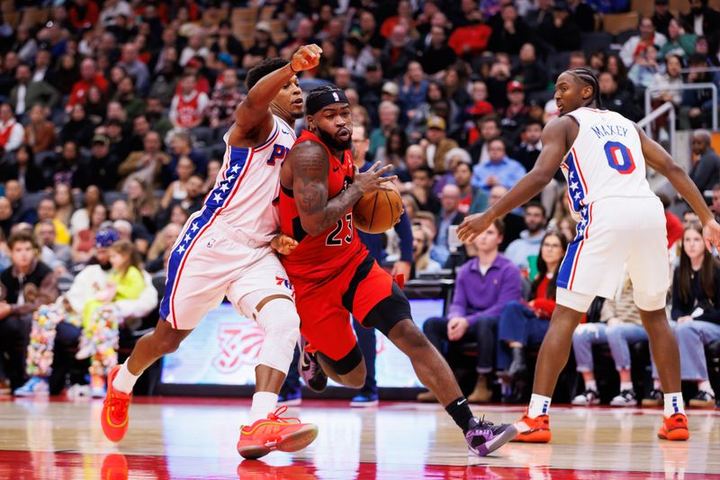 TORONTO, CANADA - OCTOBER 25: Jamal Shead #23 of the Toronto Raptors drives around Kyle Lowry #7 of the Philadelphia 76ers during the second half of their NBA game at Scotiabank Arena on October 25, 2024 in Toronto, Ontario, Canada. NOTE TO USER: User expressly acknowledges and agrees that, by downloading and or using this photograph, User is consenting to the terms and conditions of the Getty Images License Agreement. (Photo by Cole Burston/Getty Images)