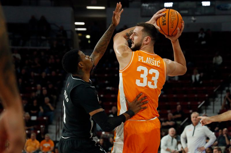 Jan 17, 2023; Starkville, Mississippi, USA; Tennessee Volunteers forward Uros Plavsic (33) looks for an open lane as Mississippi State Bulldogs forward Tolu Smith (1) defends during the first half at Humphrey Coliseum. Mandatory Credit: Petre Thomas-USA TODAY Sports