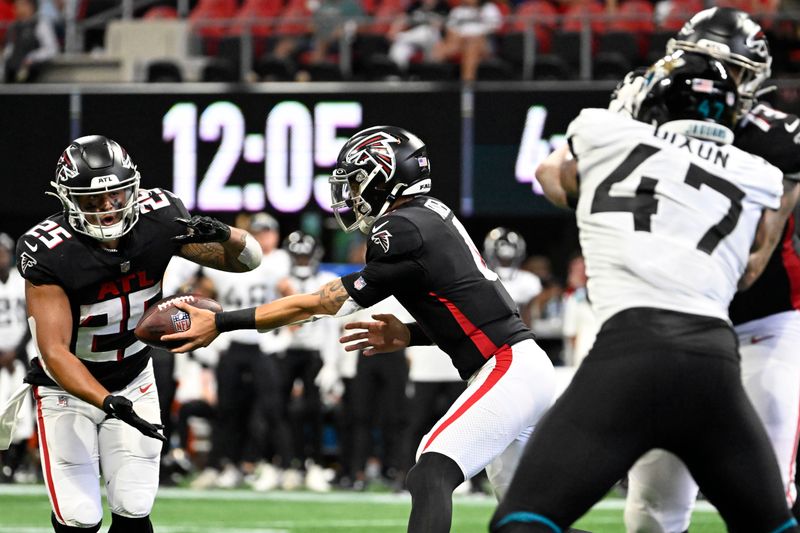 Atlanta Falcons running back Tyler Allgeier (25) takes the handoff against the Jacksonville Jaguars during the second half of an NFL football game, Saturday, Aug. 27, 2022, in Atlanta. Allgeier scored a touchdown on the play. (AP Photo/Danny Karnik)