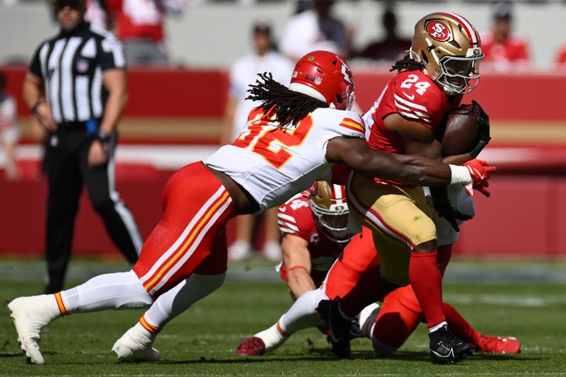 San Francisco 49ers running back Jordan Mason (24) runs against Kansas City Chiefs linebacker Nick Bolton (32) during the first half of an NFL football game in Santa Clara, Calif., Sunday, Oct. 20, 2024. (AP Photo/Eakin Howard)