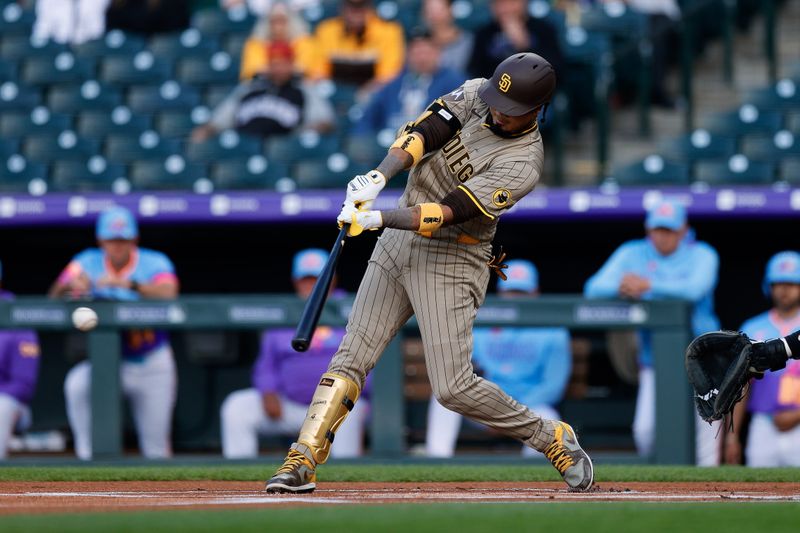 May 9, 2025; Denver, Colorado, USA; San Diego Padres first baseman Luis Arraez (4) hits a single in the first inning against the Colorado Rockies at Coors Field. Mandatory Credit: Isaiah J. Downing-Imagn Images
