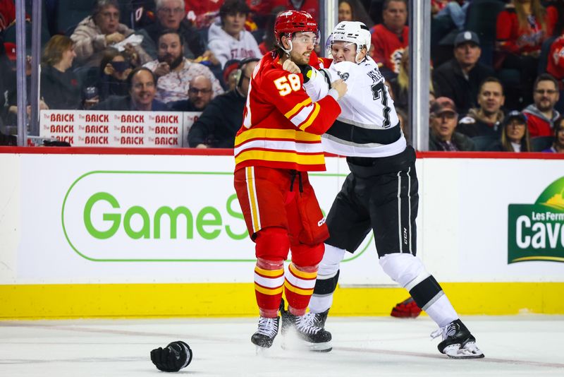 Nov 11, 2024; Calgary, Alberta, CAN; Calgary Flames center Justin Kirkland (58) and Los Angeles Kings center Samuel Helenius (79) fights during the second period at Scotiabank Saddledome. Mandatory Credit: Sergei Belski-Imagn Images