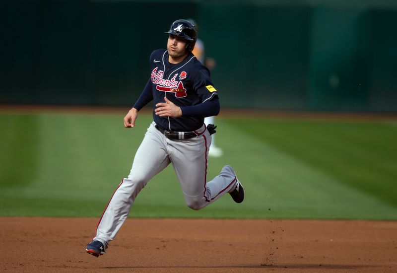 May 29, 2023; Oakland, California, USA; Atlanta Braves third baseman Austin Riley goes from first to third on an RBI single by Sean Murphy during the first inning against the Oakland Athletics at Oakland-Alameda County Coliseum. Mandatory Credit: D. Ross Cameron-USA TODAY Sports