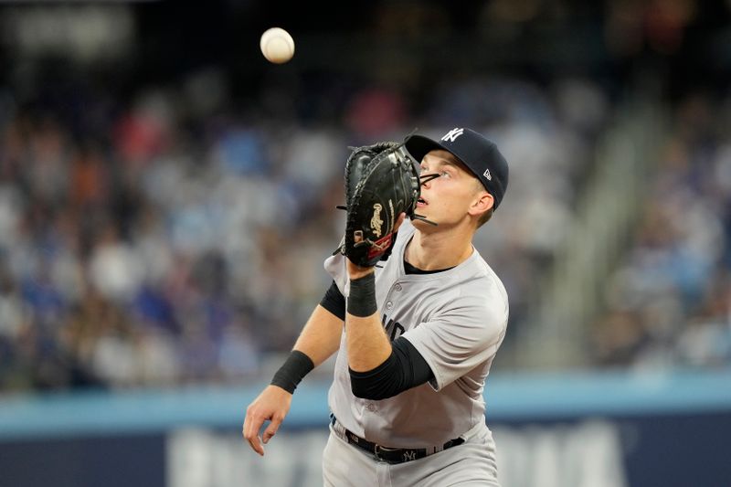 Jun 27, 2024; Toronto, Ontario, CAN; New York Yankees first baseman Ben Rice (93) catches a fly ball hit by Toronto Blue Jays second baseman Isiah Kiner-Falefa (not pictured) during the sixth inning at Rogers Centre. Mandatory Credit: John E. Sokolowski-USA TODAY Sports