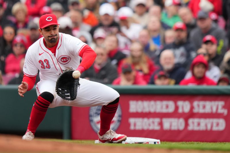 April 21, 2024; Cincinnati, Ohio, USA; Cincinnati Reds first base Christian Encarnacion-Strand (33) receives a throw for an out in the first inning of a baseball game against the Los Angeles Angels at Great American Ball Park. Mandatory Credit: Kareem Elgazzar/USA TODAY Sports via The Cincinnati Enquirer

