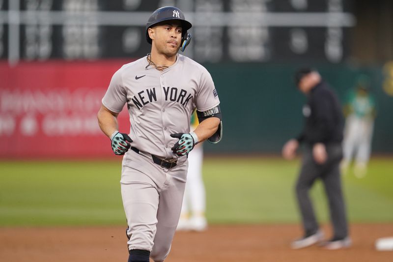 Sep 21, 2024; Oakland, California, USA; New York Yankees designated hitter Giancarlo Stanton (27) prepares to round third base after hitting a three-run home run against the Oakland Athletics in the third inning at the Oakland-Alameda County Coliseum. Mandatory Credit: Cary Edmondson-Imagn Images