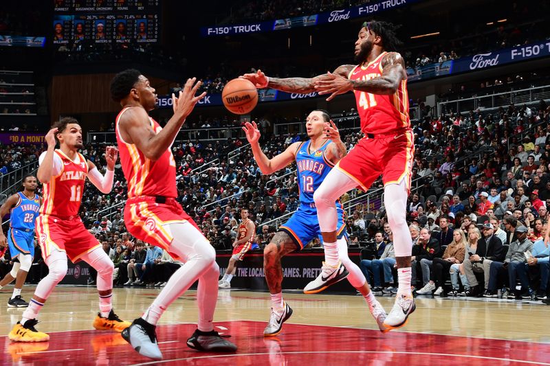 ATLANTA, GA - JANUARY 3: Saddiq Bey #41 of the Atlanta Hawks reaches for a loose ball during the game against the Oklahoma City Thunder on January 3, 2024 at State Farm Arena in Atlanta, Georgia.  NOTE TO USER: User expressly acknowledges and agrees that, by downloading and/or using this Photograph, user is consenting to the terms and conditions of the Getty Images License Agreement. Mandatory Copyright Notice: Copyright 2024 NBAE (Photo by Scott Cunningham/NBAE via Getty Images)