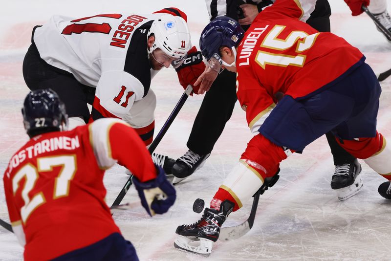 Nov 14, 2024; Sunrise, Florida, USA; New Jersey Devils right wing Stefan Noesen (11) and Florida Panthers center Anton Lundell (15) face-off during the third period at Amerant Bank Arena. Mandatory Credit: Sam Navarro-Imagn Images