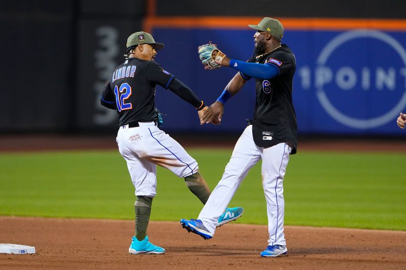 May 21, 2023; New York City, New York, USA; New York Mets shortstop Francisco Lindor (12) and right fielder Starling Marte (6) low five to celebrate the victory after the game against the Cleveland Guardians at Citi Field. Mandatory Credit: Gregory Fisher-USA TODAY Sports